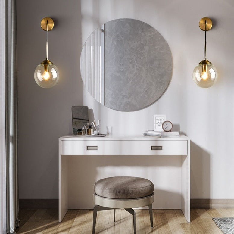 Stylish wall light fixture in a modern dressing area with a round mirror and elegant chair