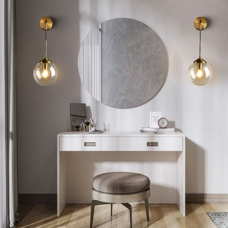 Stylish wall light fixture in a modern dressing area with a round mirror and elegant chair