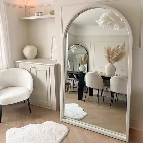 Stylish Nisu Home Wall Mirror in an arched frame reflecting a modern living space with soft furnishings