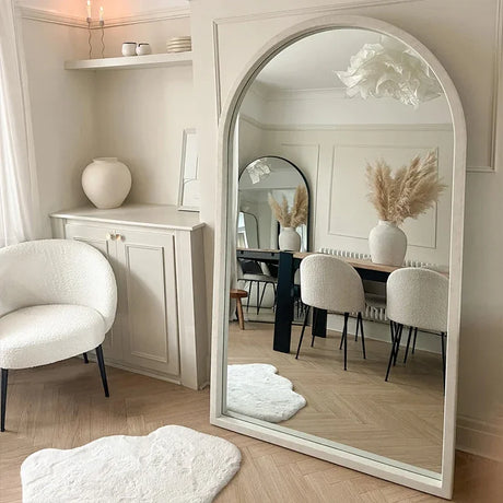 Elegant Nisu Home Wall Mirror with a modern arch design reflecting a stylish dining area