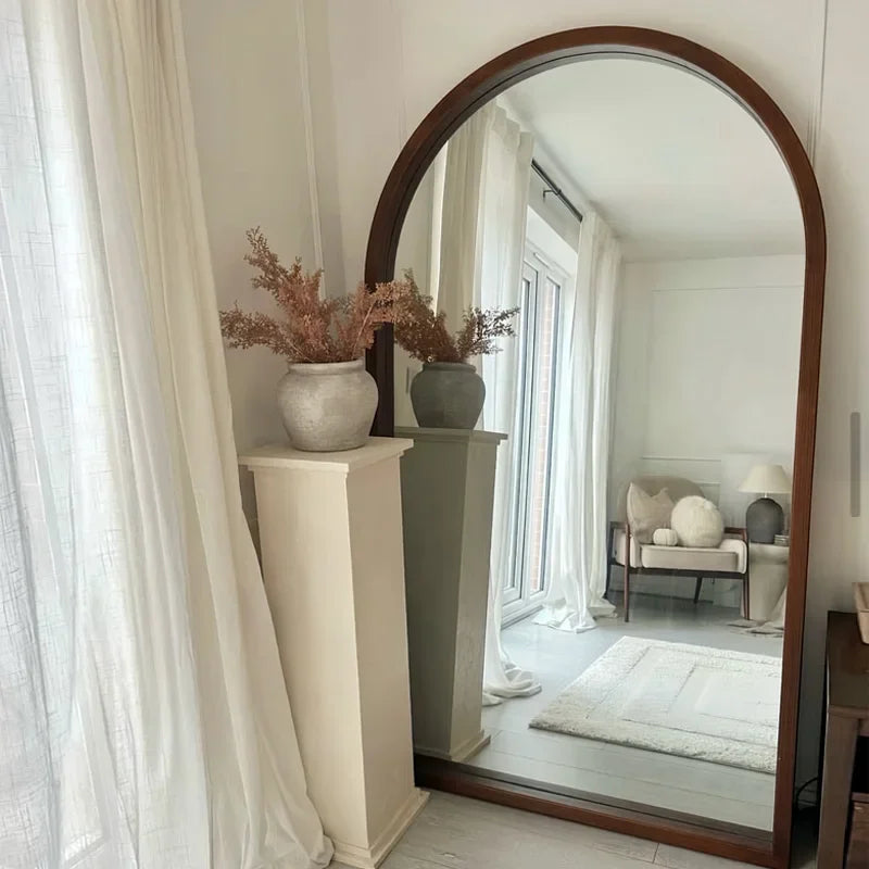 Elegant Nisu Home Wall Mirror with a wooden frame, reflecting a stylish room interior