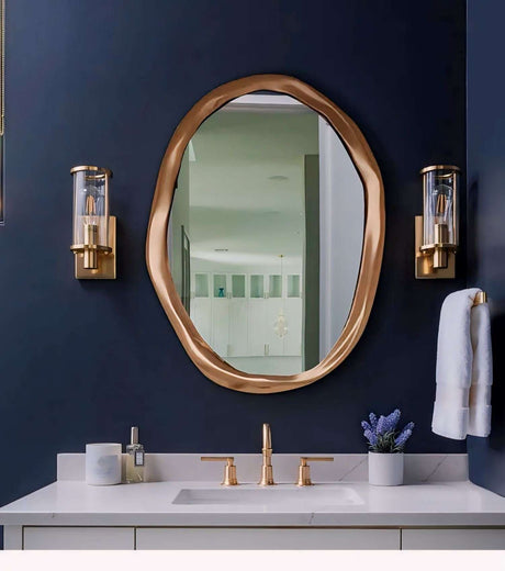 Elegant Nisu Home Wall Mirror with a unique organic shape and a gold frame, perfect for modern bathrooms