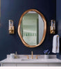 Elegant Nisu Home Wall Mirror with a unique organic shape and a gold frame, perfect for modern bathrooms