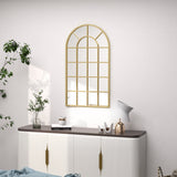 Stylish gold-framed wall mirror in an arch design above a modern sideboard for elegant bathroom decor