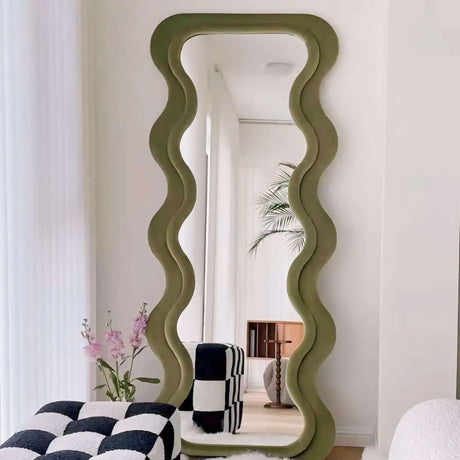 Nisu Home Wall Mirror with a wavy green frame, adding a unique touch to modern interiors