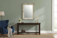Orsina Wall Mirror with Ornate Frame Above a Dark Wood Console Table in a Stylish Living Room