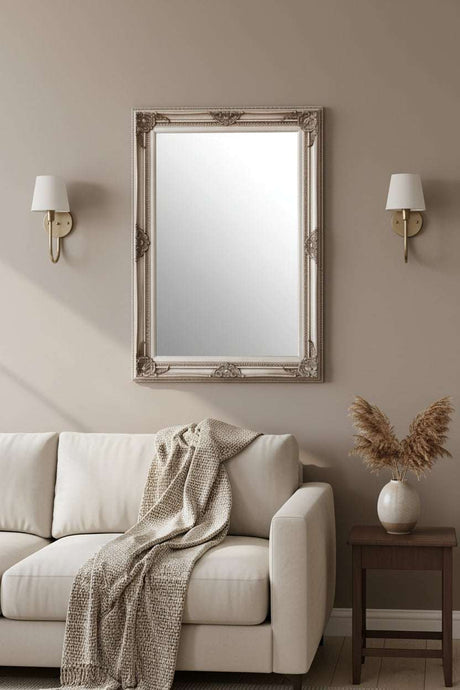 Orsina Wall Mirror in Ornate Silver Frame Above Cream Sofa in Stylish Living Room