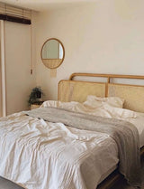 Nisu Home Wall Mirror above a styled bed with natural textures and neutral tones