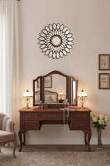 Elegant hallway wall mirror by Orsina featuring a decorative sunburst design above a vintage dressing table