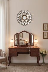 Elegant hallway wall mirror by Orsina featuring a decorative sunburst design above a vintage dressing table