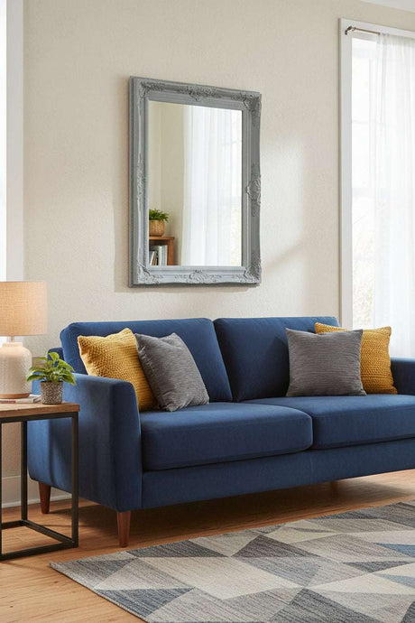 Orsina Wall Mirror in Vintage Grey Frame Above Blue Sofa with Cushions for Elegant Home Decor