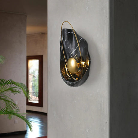Stylish modern wall sconce in black and gold, perfect for enhancing contemporary interiors