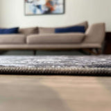 Stylish and modern washable rug placed under a sofa in a contemporary living room