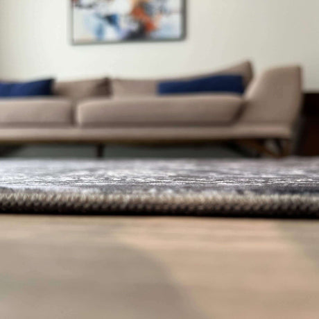 Stylish and modern washable rug placed under a sofa in a contemporary living room
