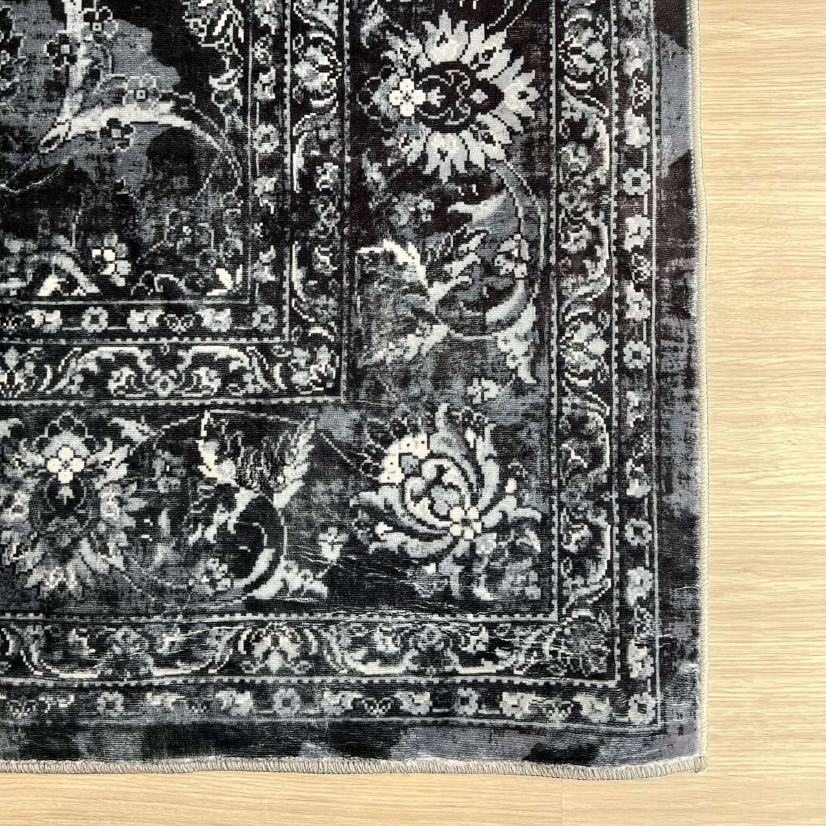 Elegant black and grey patterned washable rug with intricate floral designs for versatile decor