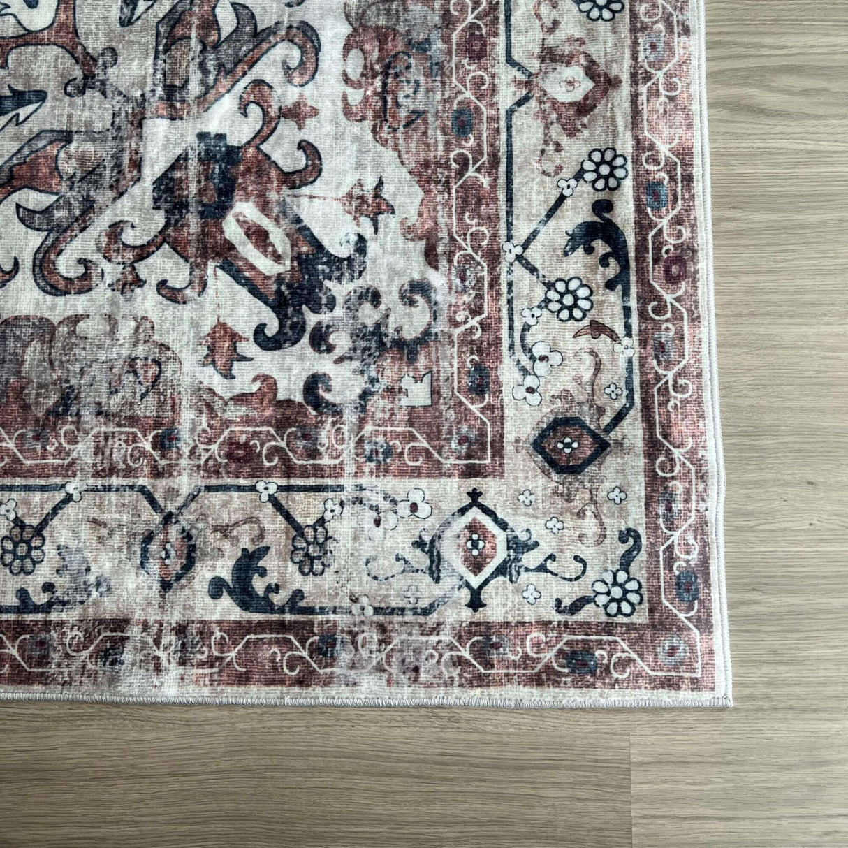 Vintage-style Washable Rug with intricate patterns in red, black, and cream colours