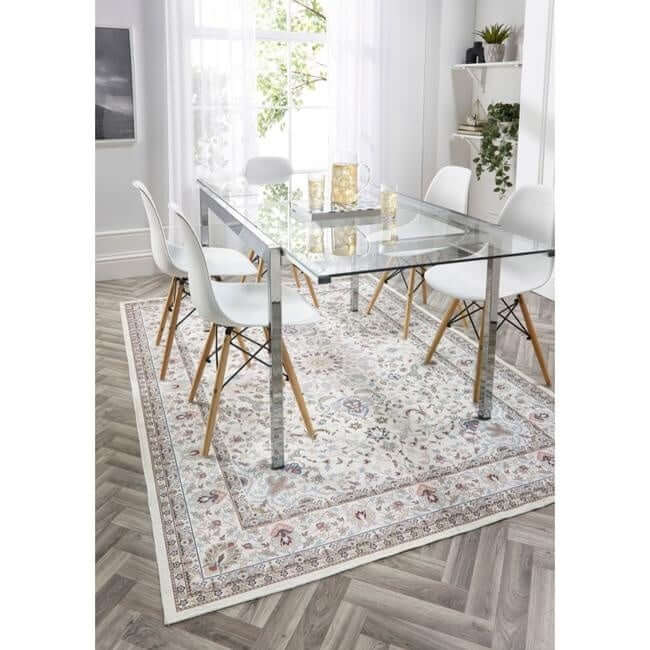 Elegant washable rug under a glass dining table with white chairs in a bright interior