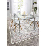 Elegant washable rug under a glass dining table with white chairs in a bright interior