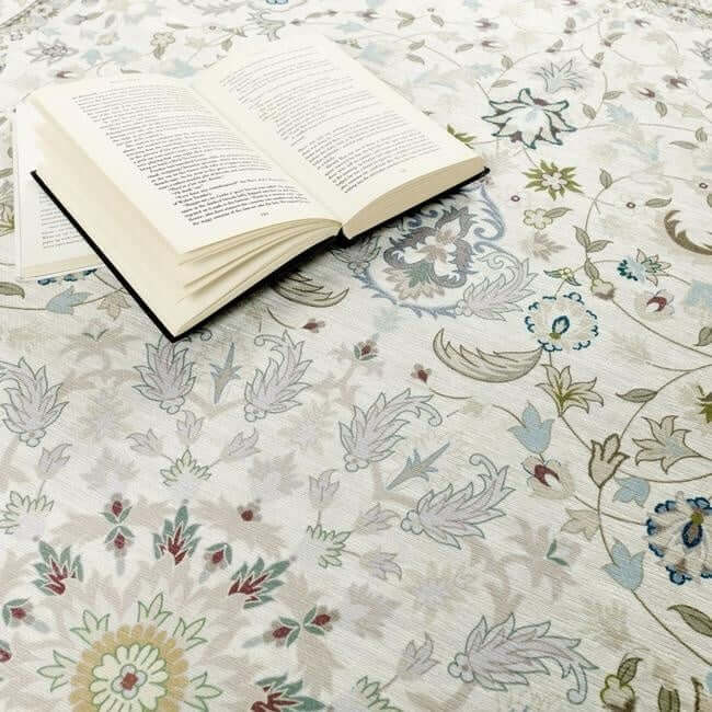 Elegant washable rug with floral patterns and a book lying on top for a cosy reading atmosphere