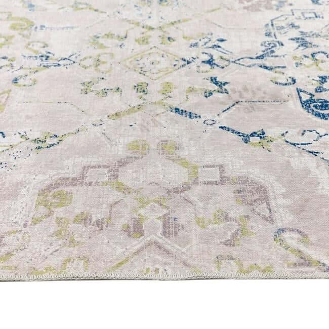 Soft and stylish washable rug with intricate patterns in neutral tones and blue accents