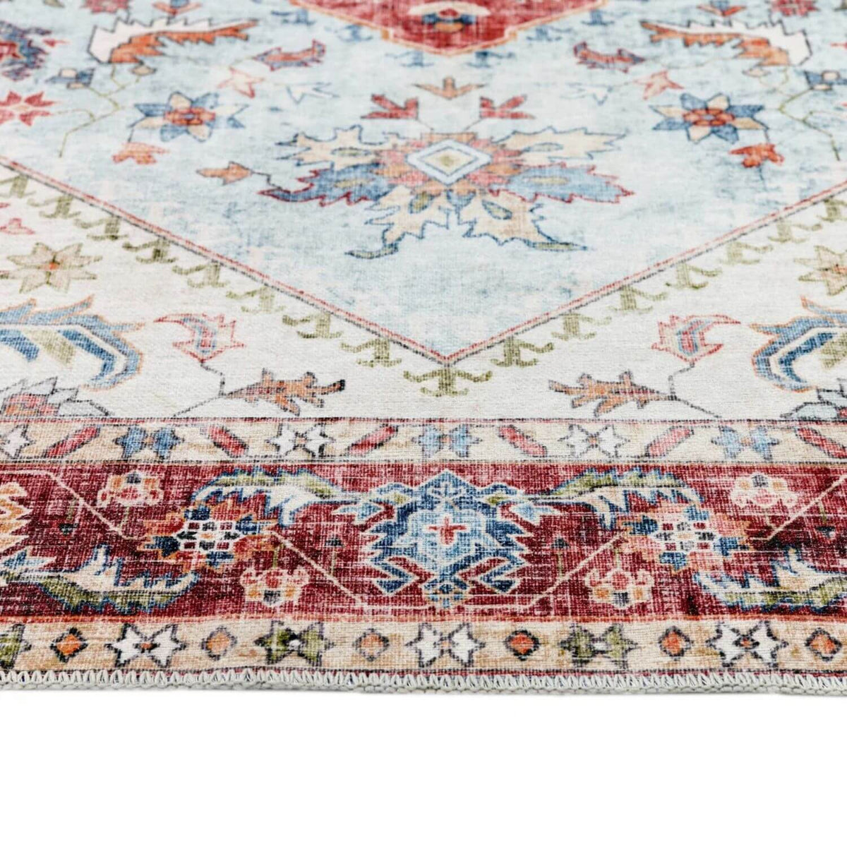 Vintage-style washable rug with intricate patterns and soft pastel colours for home decor