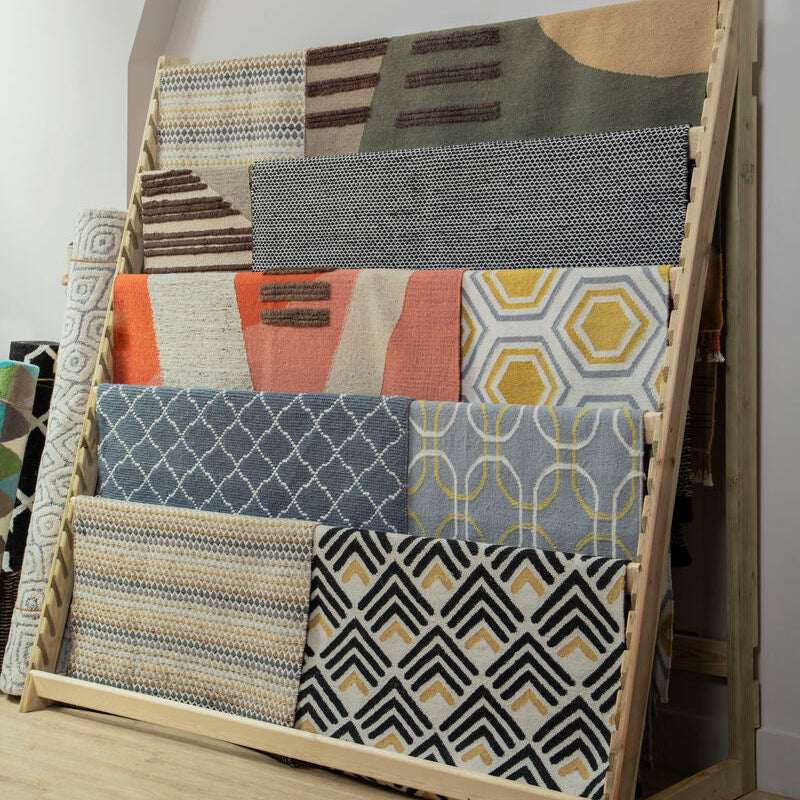 Display of various rugs including a White and Green Rug from Orsina showcasing modern designs