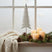 Whitewashed Tall Tree decoration on a windowsill with candles and pinecones for festive decor