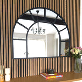 Jobu Home Window Mirror with an arch design, framed in black against a wooden backdrop