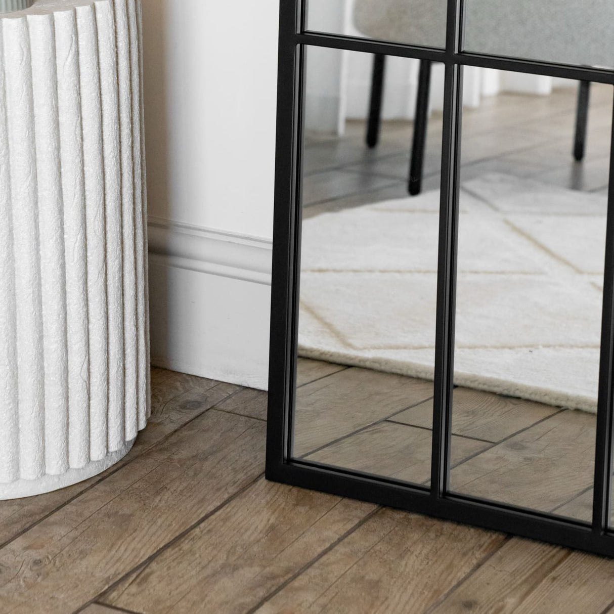 Elegant Jobu Home Window Mirror with a black frame, reflecting a stylish interior design