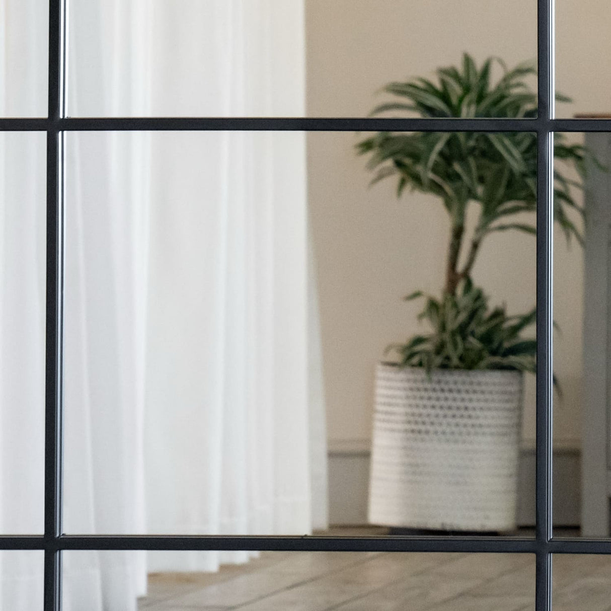 Jobu Home Window Mirror with a grid design, adding a stylish touch to any room decor