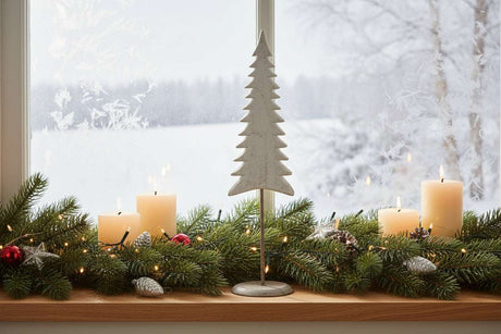 Elegant tree on stand decoration with white candles and festive greenery for Christmas room decor