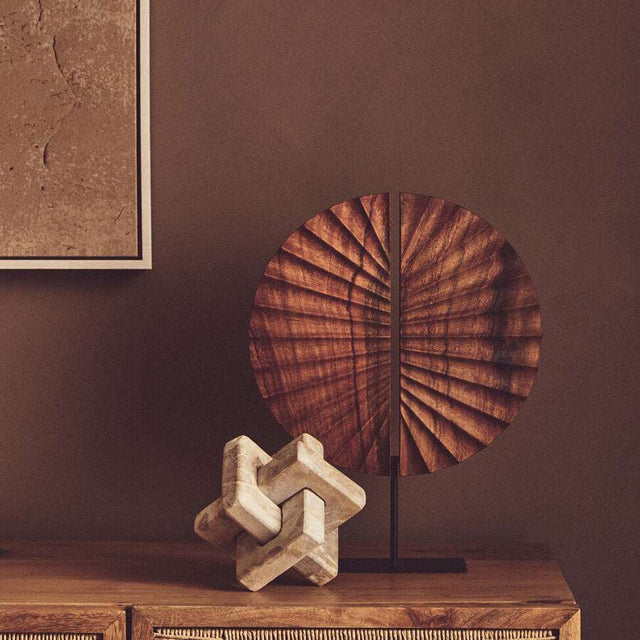 Orsina Wood Sculpture on a stylish side table with textured wall art in the background