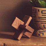 Orsina Wood Sculpture on a Wooden Surface Next to a Decorative Pot for Home Decor