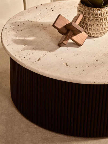 Elegant wooden sculpture displayed on a modern coffee table with a textured surface