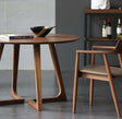 Modern Nisu Home Dining Table in a round design with wooden finish and stylish legs