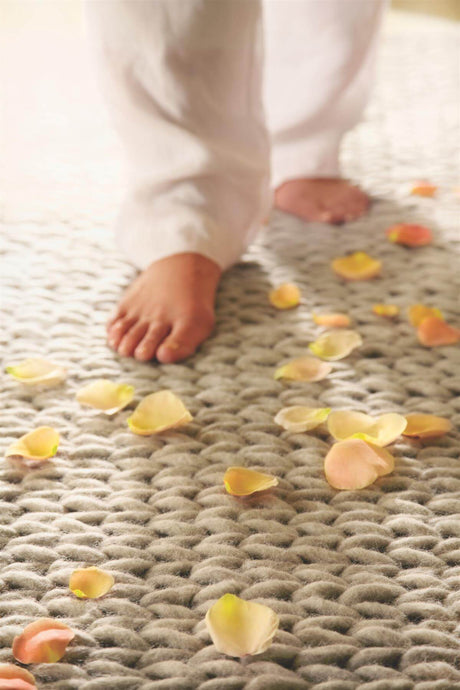 Soft Wool Rug with Barefoot Steps and Flower Petals for a Serene Atmosphere