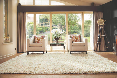 Luxurious Wool Rug on a polished wooden floor in a stylish living room with two armchairs