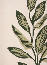 Stylish wool rug featuring a leaf design in green tones on a neutral background