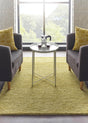 Cozy yellow wool rug placed between two grey armchairs in a bright living room
