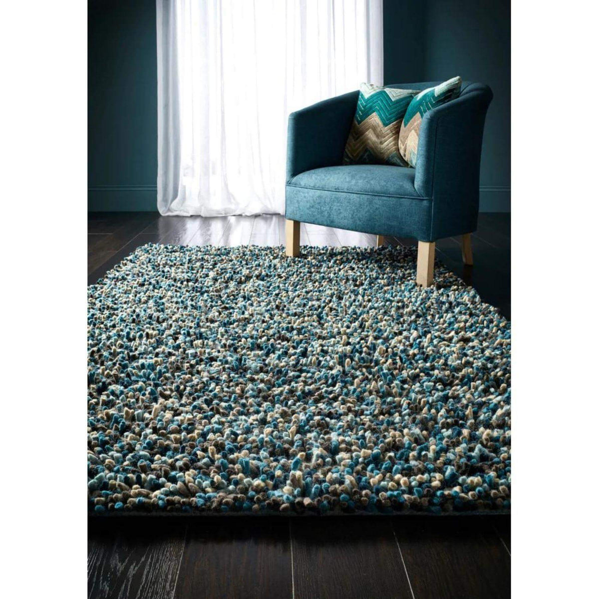 Soft wool rug in turquoise and beige tones, enhancing living spaces with texture and comfort