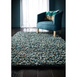 Soft wool rug in turquoise and beige tones, enhancing living spaces with texture and comfort