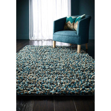 Soft wool rug in turquoise and beige tones, enhancing living spaces with texture and comfort